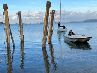 Boat towing a Fife towards the crane